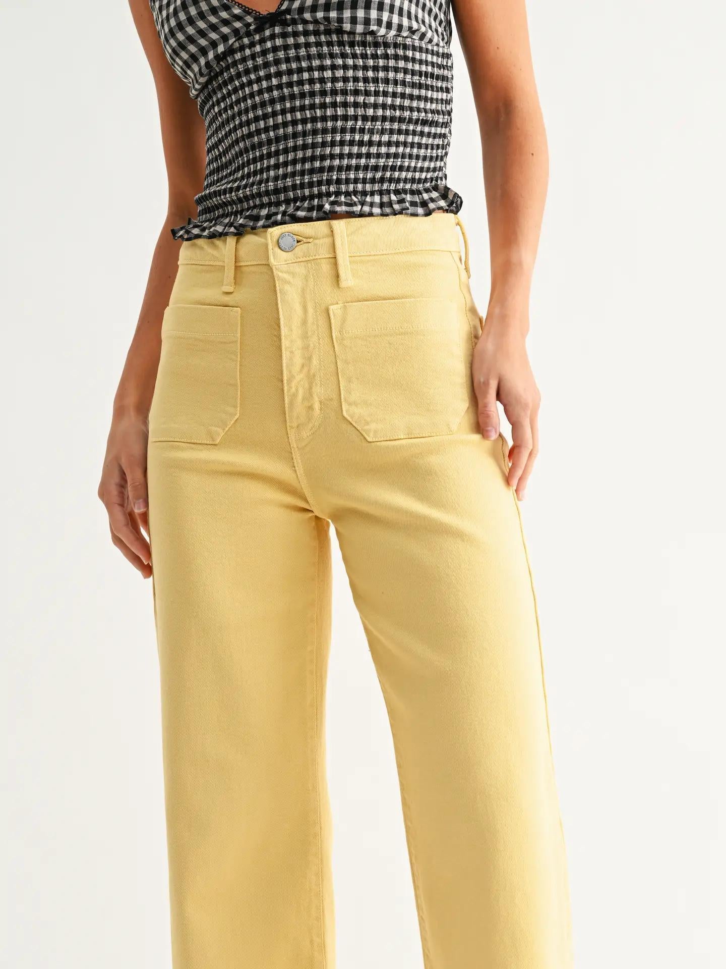 Yellow jeans wit a pocket on the front.