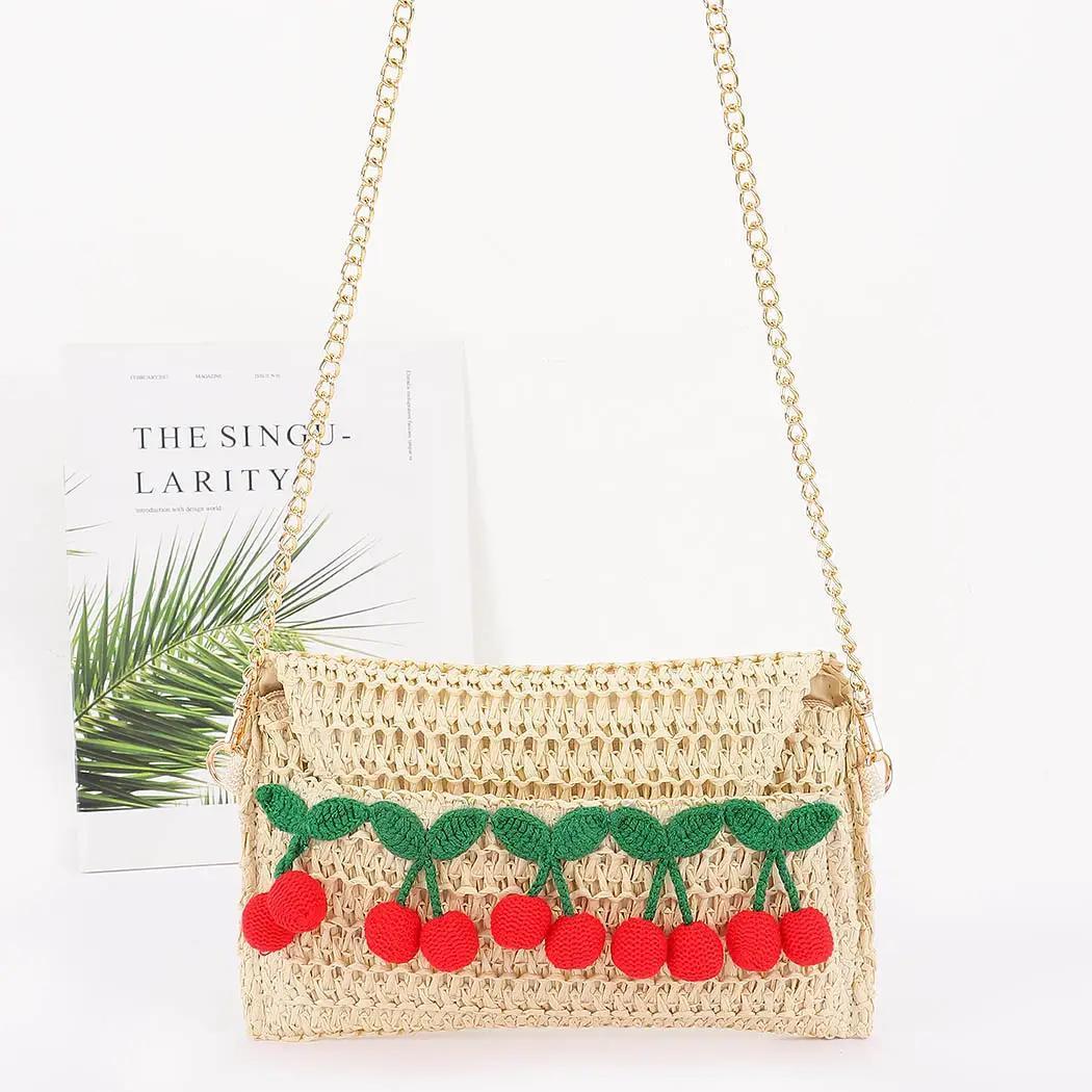 Straw bag with knit cherries and gold chain. 