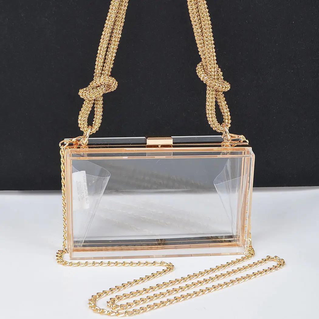 Clear bag with rhinestone handle and long gold chain. 