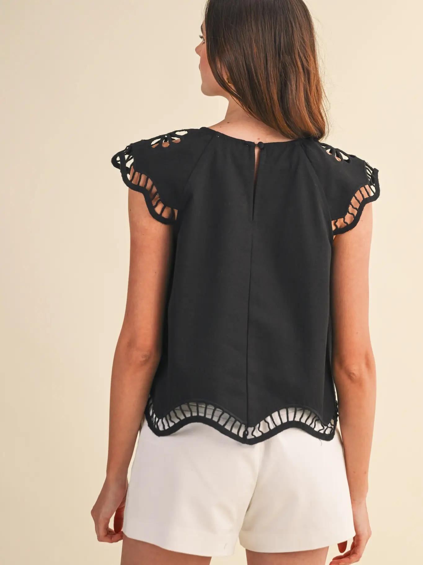 Black tank with white shorts. 