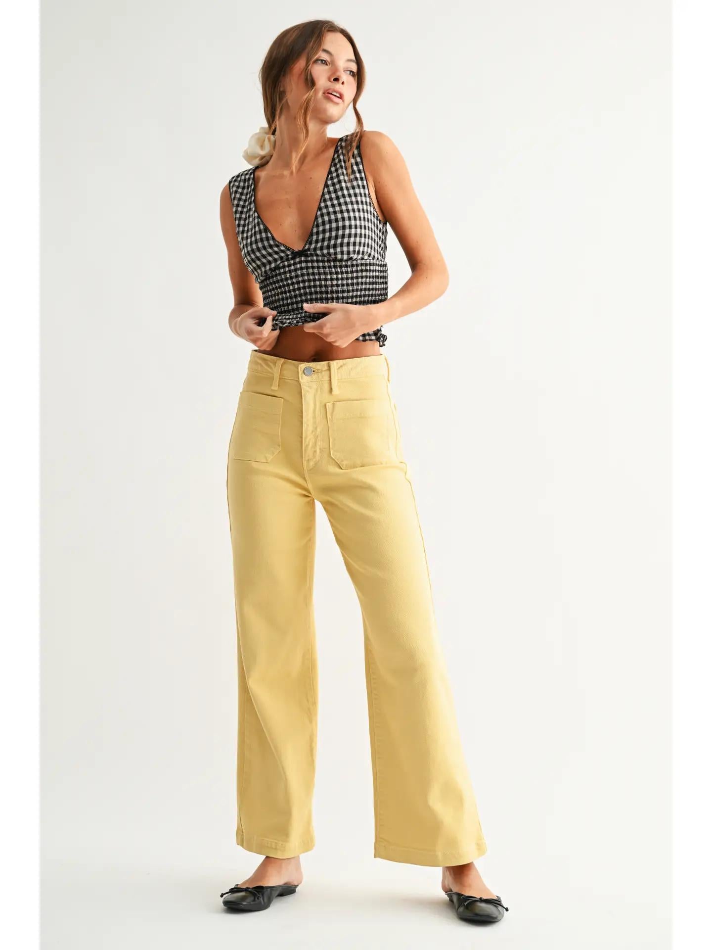 Black gingham top with dark yellow jeans and black ballet flats. 