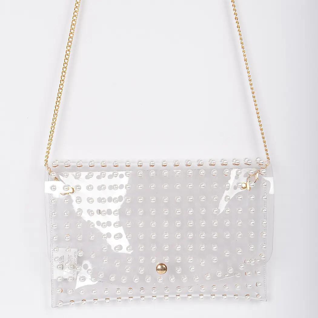 Clear bag with pearls against white background. 