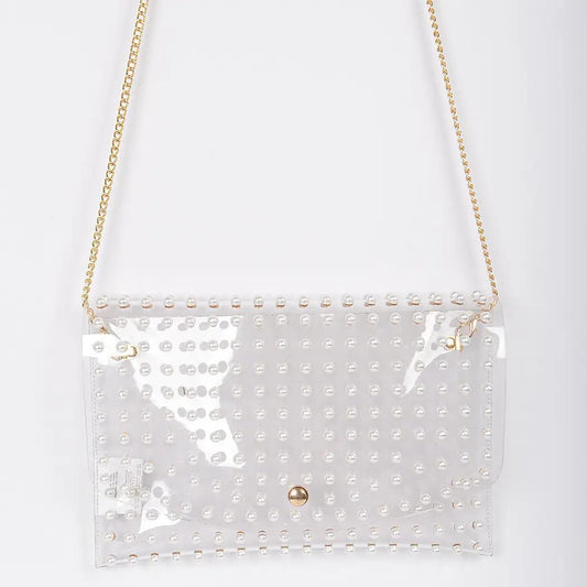 Clear bag with pearls against white background. 